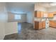 Kitchen with wood cabinets, white appliances, and an open view to the living area at 3236 Idaho Springs St, North Las Vegas, NV 89032