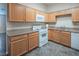 Functional kitchen area with wood cabinets, granite counters, and essential appliances at 3236 Idaho Springs St, North Las Vegas, NV 89032