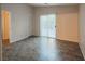 A well-lit living room featuring tile floors, a sliding glass door, and neutral walls at 3236 Idaho Springs St, North Las Vegas, NV 89032