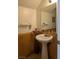 Small half bathroom with pedestal sink and wood wainscotting at 3681 Hidden Beach Ct, Las Vegas, NV 89115