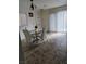 Light-filled dining area with tile floors, a modern table, and white chairs at 3681 Hidden Beach Ct, Las Vegas, NV 89115