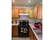 A kitchen featuring wooden cabinets and a black gas range at 3681 Hidden Beach Ct, Las Vegas, NV 89115