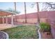 Landscaped backyard featuring grass, rocks and trees alongside the covered patio at 3725 Shanagolden St, Las Vegas, NV 89129