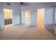 Carpeted bedroom with an ensuite bathroom, walk-in closet, and access to the home's second story at 3725 Shanagolden St, Las Vegas, NV 89129