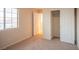 Bright bedroom with neutral carpet, a window, closet, and a door at 3725 Shanagolden St, Las Vegas, NV 89129