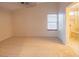 This bedroom is carpeted and features a window and ensuite bathroom with shower at 3725 Shanagolden St, Las Vegas, NV 89129