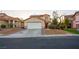 Two-story home with a well-manicured lawn, mature trees, and a two-car garage at 3725 Shanagolden St, Las Vegas, NV 89129