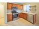 Well-lit kitchen featuring stainless steel appliances, wood cabinets, and tile flooring at 3725 Shanagolden St, Las Vegas, NV 89129