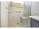 Modern shower with a stone-tiled seat, unique tile flooring, and adjustable shower head at 3725 Shanagolden St, Las Vegas, NV 89129