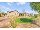 Landscaped backyard with covered patio, turf, and desert landscaping at 3914 Jacob Lake Cir, Las Vegas, NV 89118
