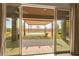 View from inside the house to the covered patio and stone landscaped backyard at 3914 Jacob Lake Cir, Las Vegas, NV 89118