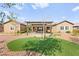 Beautiful backyard with a patio cover, desert landscaping and artificial turf at 3914 Jacob Lake Cir, Las Vegas, NV 89118