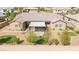 Backyard featuring a covered patio, decorative grass accents, and desert landscaping for easy maintenance at 3914 Jacob Lake Cir, Las Vegas, NV 89118