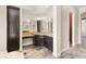 Bathroom featuring dark wood cabinets, granite countertops, and built-in storage at 3914 Jacob Lake Cir, Las Vegas, NV 89118