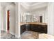 Bathroom featuring dark wood cabinets, granite countertops and a double vanity at 3914 Jacob Lake Cir, Las Vegas, NV 89118