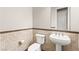 Contemporary bathroom features tiled walls, pedestal sink, and modern fixtures at 3914 Jacob Lake Cir, Las Vegas, NV 89118