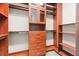 Custom walk-in closet features dark wood shelving and cabinets with ample storage at 3914 Jacob Lake Cir, Las Vegas, NV 89118