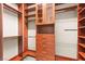 Spacious walk-in closet with custom wood shelving and storage drawers at 3914 Jacob Lake Cir, Las Vegas, NV 89118