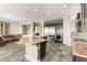 Large kitchen featuring a curved island with granite countertops, stainless steel appliances, and custom cabinetry at 3914 Jacob Lake Cir, Las Vegas, NV 89118