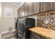 Convenient laundry room with overhead cabinets and granite countertops at 3914 Jacob Lake Cir, Las Vegas, NV 89118