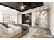Staged main bedroom with a tray ceiling and sliding doors to a study at 3914 Jacob Lake Cir, Las Vegas, NV 89118