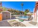 Private backyard features a sparkling pool, spa, shed, and lush landscaping at 4095 Ridgewood Ave, Las Vegas, NV 89120