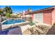 Beautiful backyard with a refreshing pool, spa, mature landscaping, and shaded patio area at 4095 Ridgewood Ave, Las Vegas, NV 89120