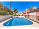 Spacious backyard with a lovely pool, jacuzzi, and outdoor seating area surrounded by greenery at 4095 Ridgewood Ave, Las Vegas, NV 89120