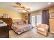 Cozy bedroom with ceiling fan, carpet floors, and glass doors leading to a private patio at 4095 Ridgewood Ave, Las Vegas, NV 89120