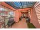 Inviting covered front porch with seating, an ornate railing and lighting at 4095 Ridgewood Ave, Las Vegas, NV 89120