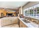 Bright kitchen featuring a stone backsplash, white countertops, and stainless steel appliances at 4095 Ridgewood Ave, Las Vegas, NV 89120