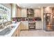 Bright kitchen features stainless appliances, stone countertops, and a tiled backsplash at 4095 Ridgewood Ave, Las Vegas, NV 89120