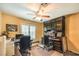 Bright office featuring a ceiling fan, carpet floors, and a wall of custom built-in storage at 4095 Ridgewood Ave, Las Vegas, NV 89120