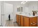 Double vanity bath with wood cabinets, white countertop, and large walk-in closet at 4305 Morgan Manor St # 3, North Las Vegas, NV 89032