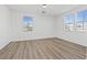 Spacious bedroom has wood floors, two sunlit windows, and neutral paint at 4305 Morgan Manor St # 3, North Las Vegas, NV 89032