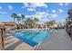 Inviting community pool surrounded by palm trees, lounge chairs, and shade umbrellas at 4305 Morgan Manor St # 3, North Las Vegas, NV 89032