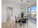 Dining area with a sliding door to a balcony and modern lighting at 4305 Morgan Manor St # 3, North Las Vegas, NV 89032