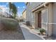 The front entrance of a home is complemented by rock landscaping and a well-maintained walkway at 4305 Morgan Manor St # 3, North Las Vegas, NV 89032