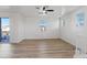 Bright living room with wood floors, a ceiling fan, and balcony access with views at 4305 Morgan Manor St # 3, North Las Vegas, NV 89032