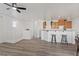 Open living area with wood floors, recessed lighting, breakfast bar, and white walls at 4305 Morgan Manor St # 3, North Las Vegas, NV 89032