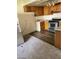Kitchen featuring stainless steel appliances, wood cabinets, and durable laminate flooring at 4720 Obannon Dr # D, Las Vegas, NV 89102
