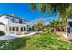 Expansive backyard featuring a large patio, lush lawn, and a sparkling pool area at 4880 Hayride St, Las Vegas, NV 89149