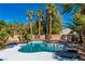 Sparkling backyard pool and spa surrounded by palm trees and a spacious patio at 4880 Hayride St, Las Vegas, NV 89149