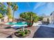 Inviting backyard with a pool, spa, mature trees, and outdoor seating area at 4880 Hayride St, Las Vegas, NV 89149