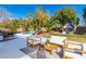 A backyard oasis features a pool, landscaping, a patio, and a charming playhouse at 4880 Hayride St, Las Vegas, NV 89149