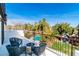 Balcony features outdoor seating and a fire pit overlooking the backyard pool at 4880 Hayride St, Las Vegas, NV 89149