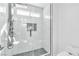 Modern bathroom with a sleek glass shower featuring dual shower heads and elegant marble tiling at 4880 Hayride St, Las Vegas, NV 89149