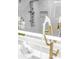 Sleek bathroom featuring a modern gold faucet, and marble details at 4880 Hayride St, Las Vegas, NV 89149