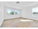 Bright bedroom featuring wood-look flooring, and a large window at 4880 Hayride St, Las Vegas, NV 89149