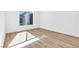 Bright bedroom with a large window and wood-look flooring, creating a welcoming and airy space at 4880 Hayride St, Las Vegas, NV 89149
